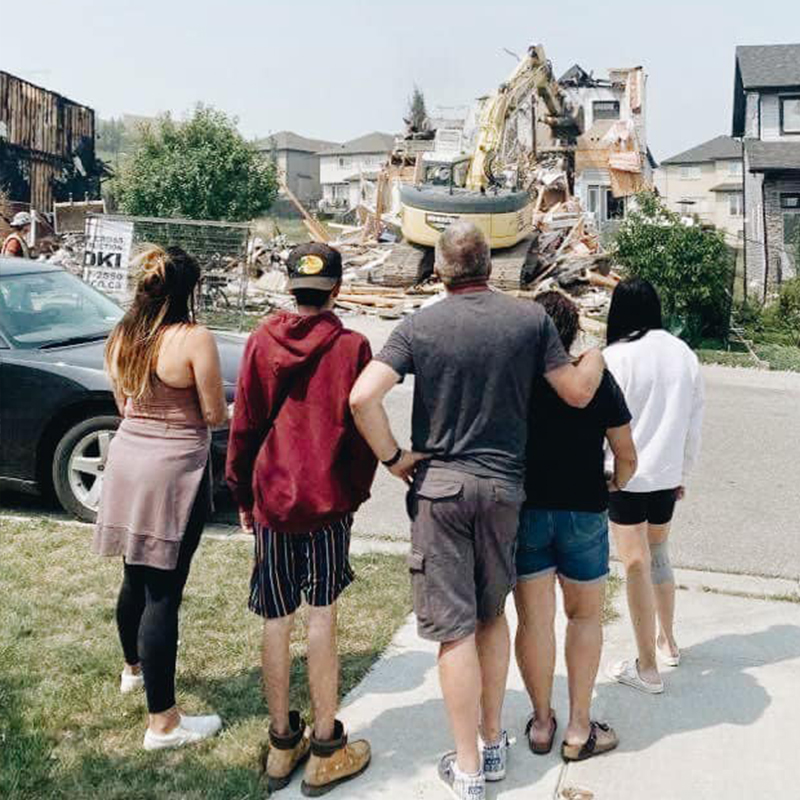 Campbell family looks at their home