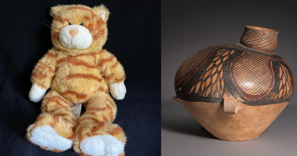 orange tabby stuffed cat and urn