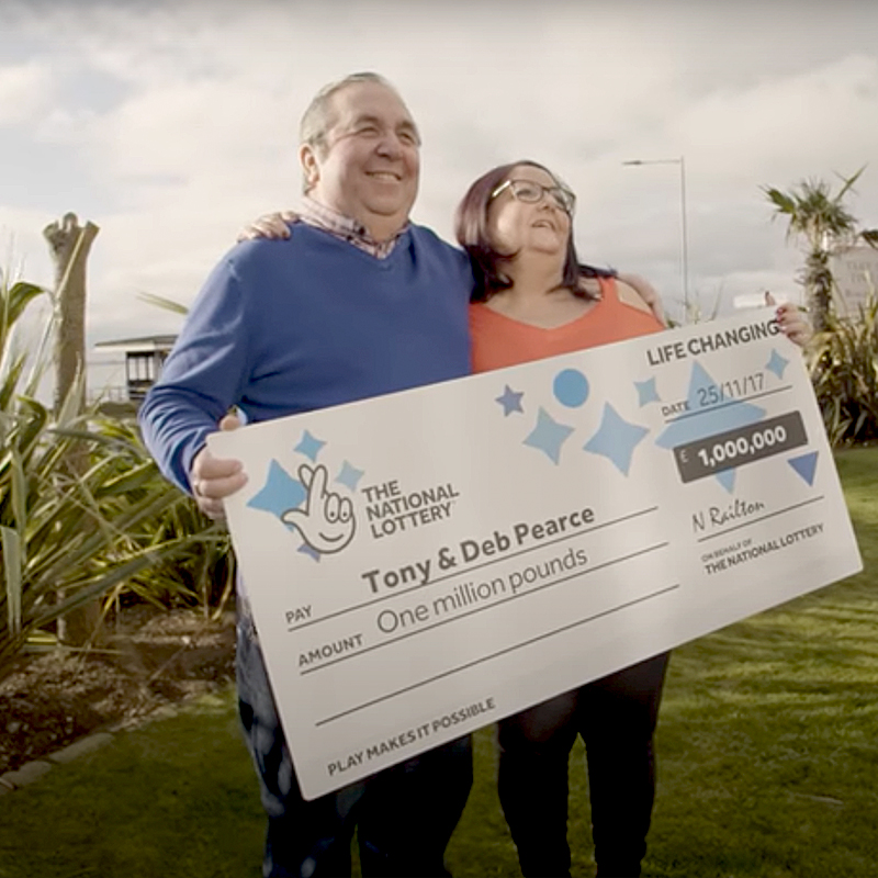 Couple holds oversized lottery check