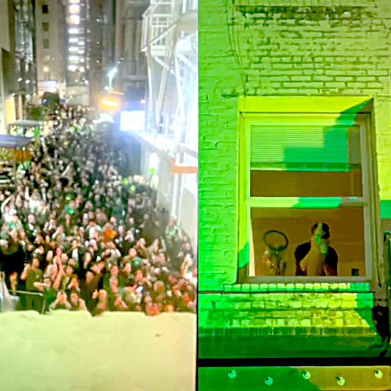 A crowd in San Francisco downtown for the St. Patrick's Day block party are surprised by a cat dancing in the window