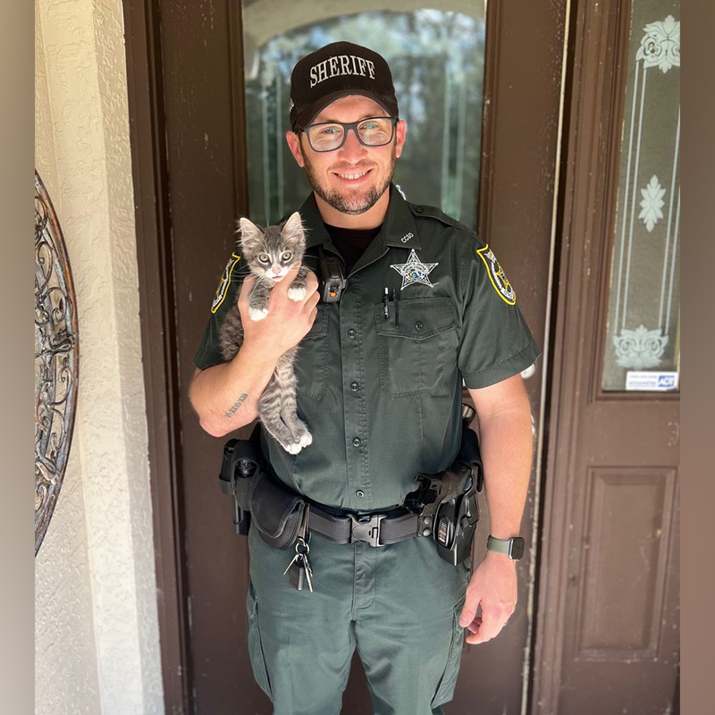 Deputy Jone holds adopted kitten Mario, that fell into a pipe, 1