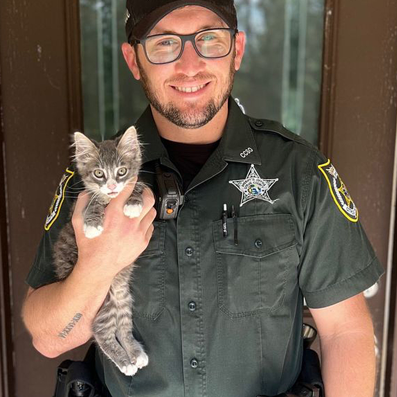 Deputy Jone holds adopted kitten Mario, that fell into a pipe, 2