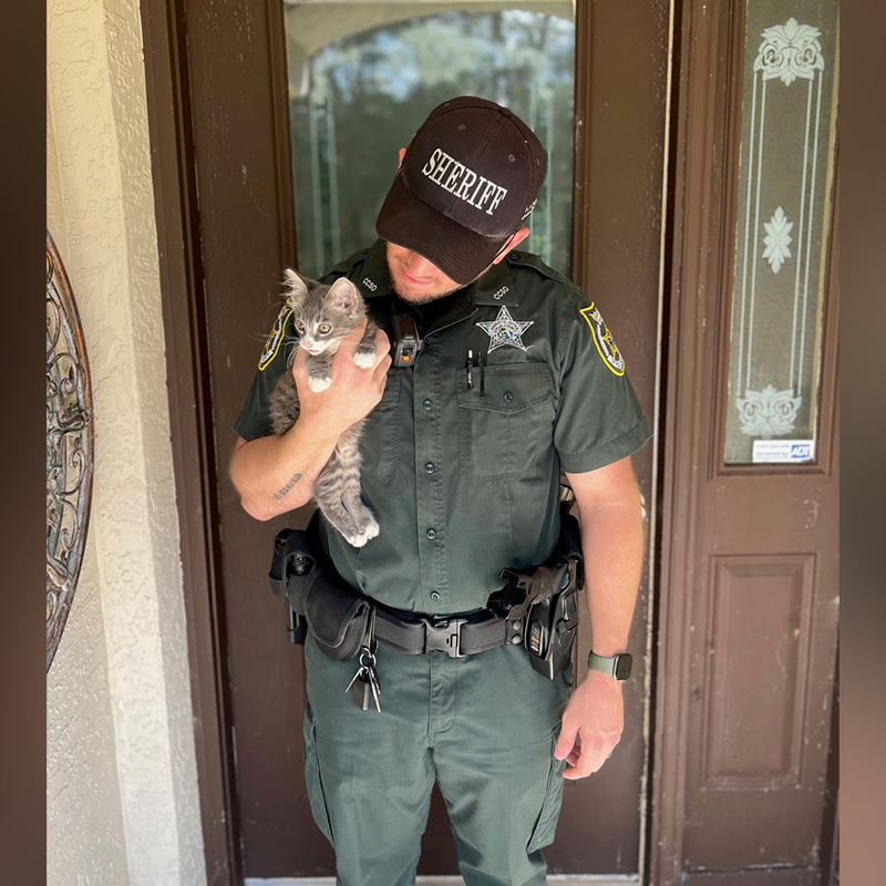Deputy Jone holds adopted kitten Mario, that fell into a pipe, 3
