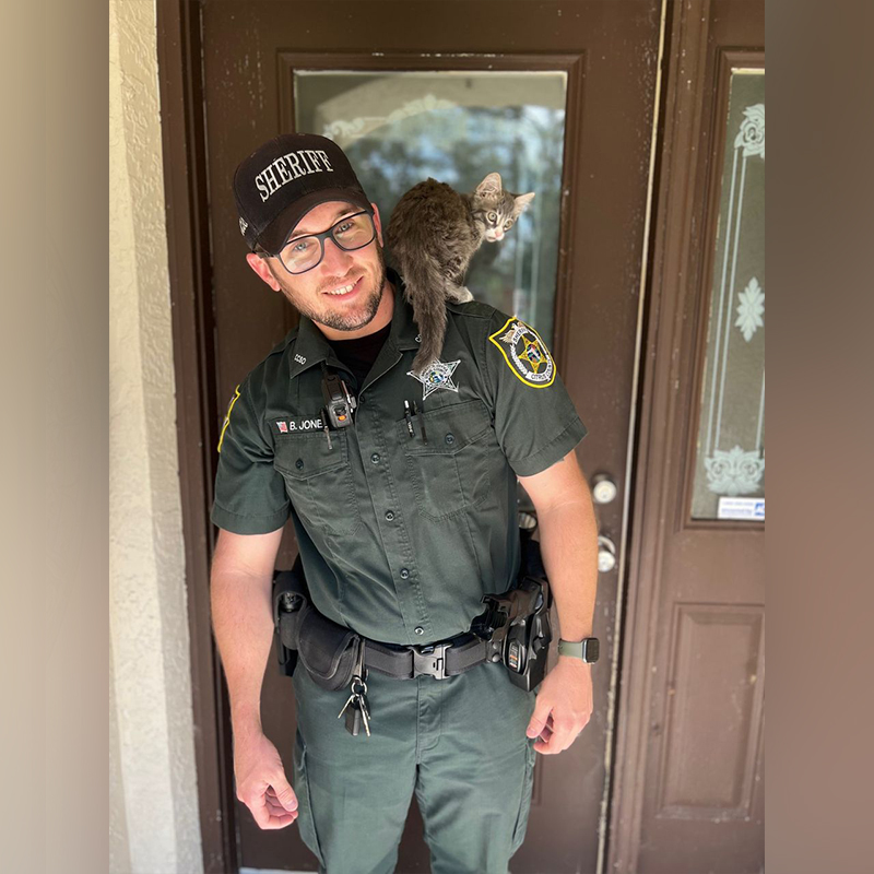 Deputy Jone holds adopted kitten Mario, that fell into a pipe, 4