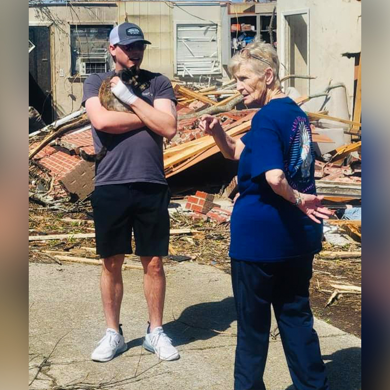Mason Long with Athena the cat after tornado in Rolling Fork, Mississippi