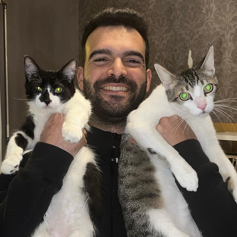 Yassine with two adult rescued cats in Morocco